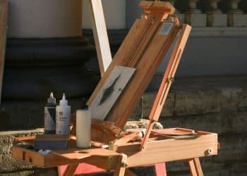 A wooden easel with a painting on top of it