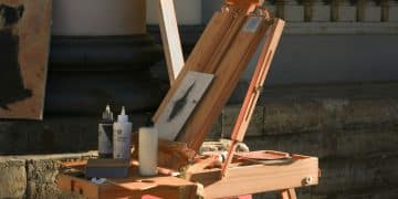 A wooden easel with a painting on top of it