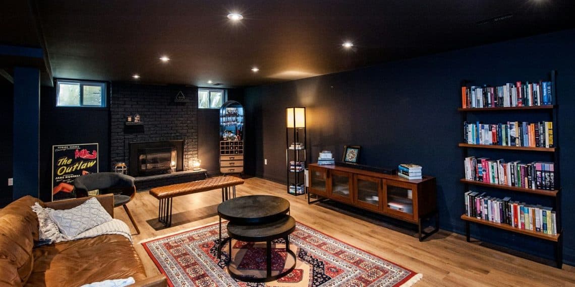 Cozy living room with fireplace and bookshelves.