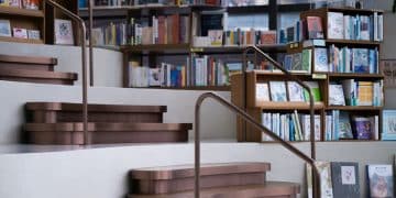 a set of stairs leading up to a bookshelf filled with books
